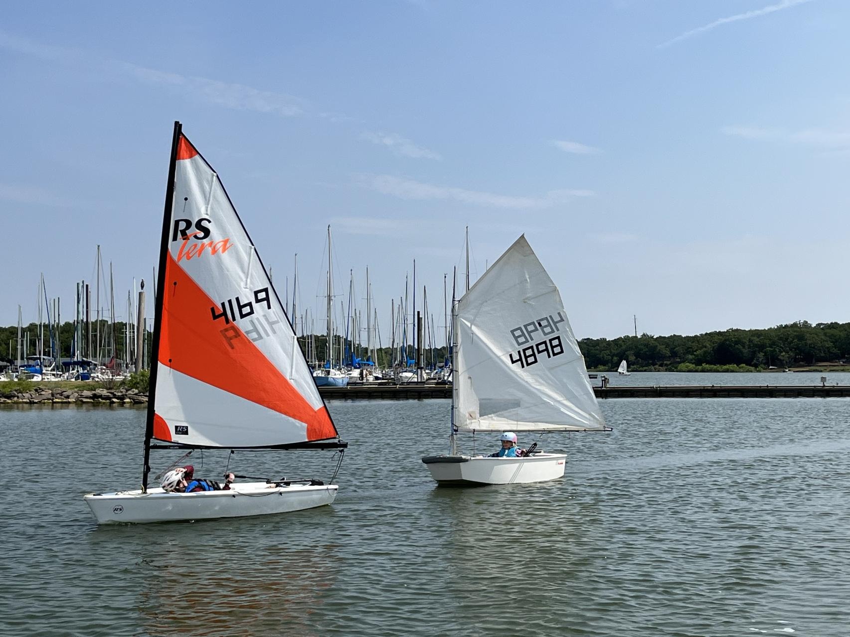 Two young sailors in RS Tera and Optimist dinghies