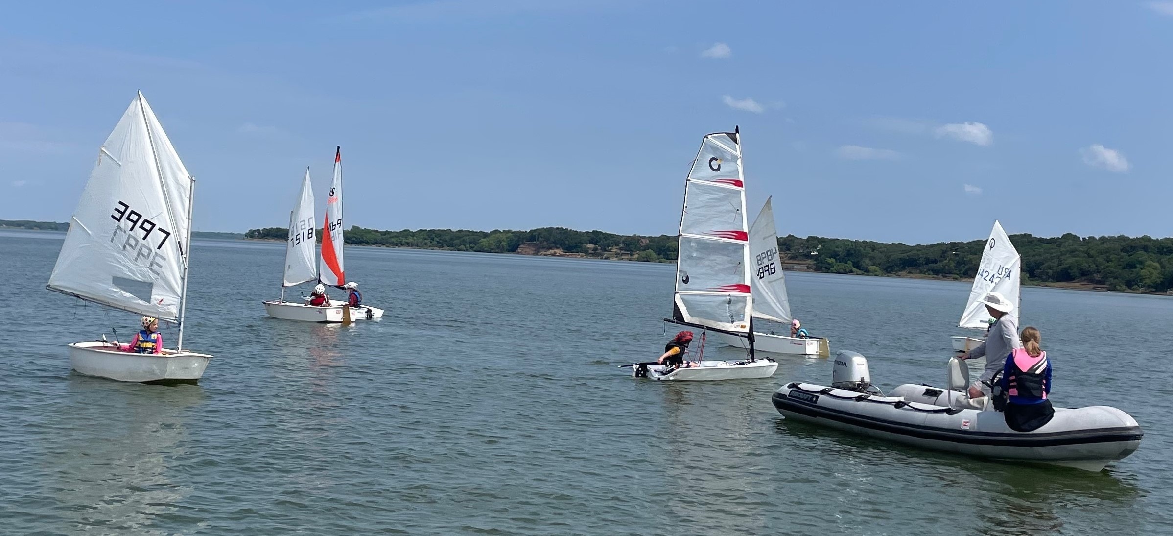 Young DCYC sailors in a fleet of small dinghies on Lake Lewisville